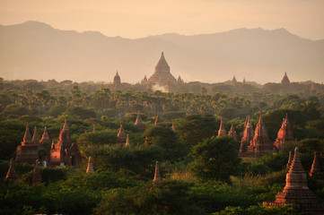 Green land with spears of temple, Picturesque landscape of green spacious terrain with spires of oriental pagodas and paya, Myanmar, Bagan. Mingalazedi Sulamani Shwezigon Ananda Htilominlo.