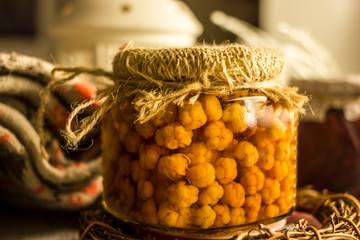 Wild berry jam cloudberry in a beautiful old-style bank