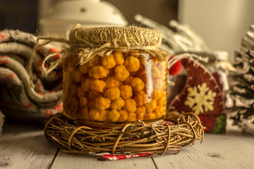 Wild berry jam cloudberry in a beautiful old-style bank