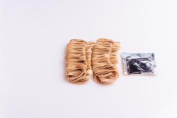 Dry uncooked whole instant noodles isolated in white background, top view, copy space, soft light, wholegrain pasta