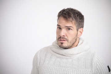 Obraz premium Man in white shirt looking scared in front of a white background