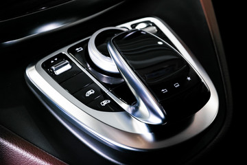 Media and navigation control buttons of a Modern car. Car interior details. Brown leather interior...