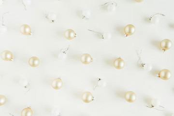 Golden Christmas balls decorations on white background. Flat lay, top view Christmas / New Year holiday composition.