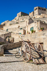 Fototapeta na wymiar Old wooden farm cart. Sassi or stones of Matera European capital of culture 2019, Basilicata, Italy
