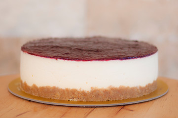 Raspberry cheesecake on wooden table