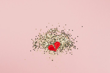 Top view of golden stars confetti broken heart