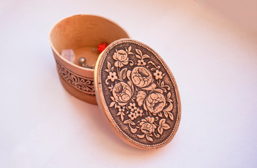 Oval birch bark box decorated with elegant floral pattern on light background