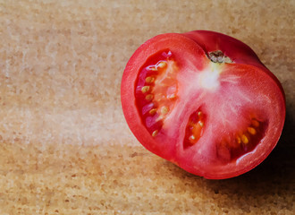 red tomato on wooden board