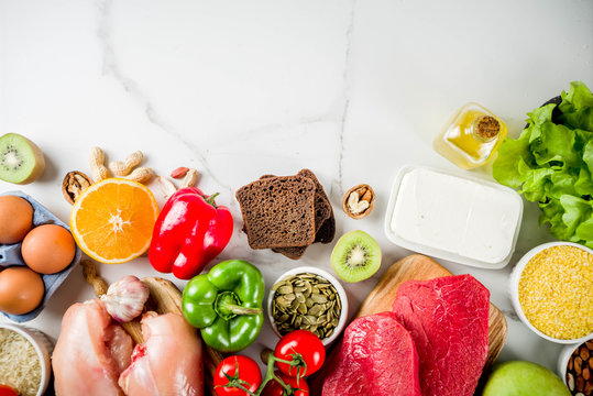 Healthy diet food. Various low fodmap ingredients selection - meat, vegetables, berry, fruit, grains, Trendy healthy lifestyle concept. On white marble background copy space top view