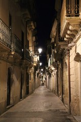 Fototapeta na wymiar Night at old alley in Ortigia Syracuse, Sicily Italy 
