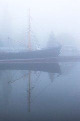 ship at the pier on the river in a thick dense fog
