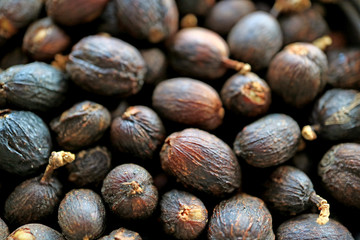 Closed up pile of dried whole coffee cherries 