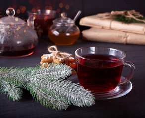 Christmas cookies snowflakes , cup of tea on the black wooden table.