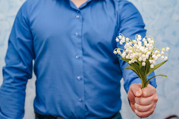 Photo of man gives lilies of the valley