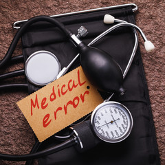 Medical equipment for measuring blood pressure and a sticker that says medical errors