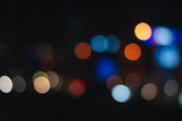 abstract light blur bokeh background from cars light in dark night traffic on the road in the city. background for celebration merry christmas and happy new year holiday.
