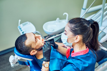 Dentist at work on a patient in clinic