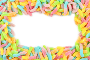 Frame of colorful gummy candies isolated on white. Top view. Space for text or design.