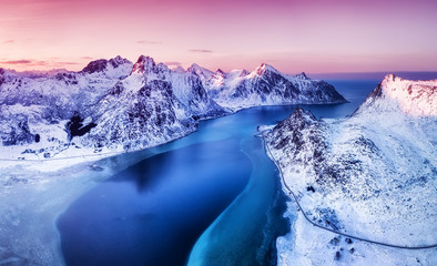 Aerial view at the Lofoten islands, Norway. Mountains and sea during sunset. Natural landscape from air at the drone. Norway at the winter time