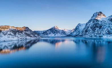 Obraz na płótnie Canvas Aerial view at the Lofoten islands, Norway. Mountains and sea during sunset. Natural landscape from air at the drone. Norway at the winter time