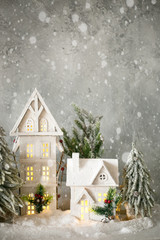 Fototapeta na wymiar Christmas decoration. Snow-covered white houses. Anticipation of the holiday. Vertical orientation