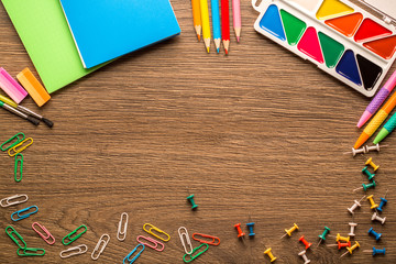 Bright school accessories, stationery on a wooden background. View from above