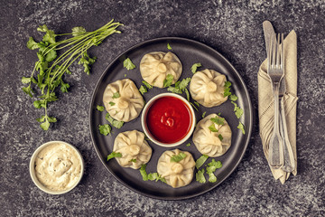 Traditional steamed dumplings Khinkali with Tomato and Tartar sauce