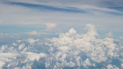 Aerial view of cloud and sky from airplane window looking down