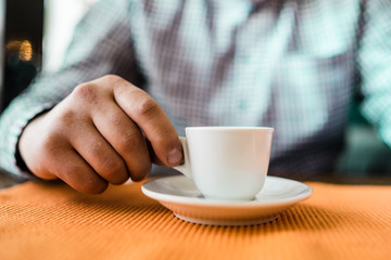 man holding cup of coffee