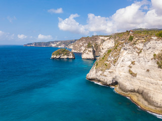 Small islands and ocean cliff near Atuh beach at Nusa Penida known as Raja Lima or the five kings. Aerial photo from drone. Indonesia.