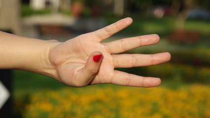 Female Hand Counting Four