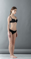 Standard model tests of young pretty woman on a gray background,Test Shots young models for modeling agency on a gray background with ,young beautiful woman in underwear. portrait of slim woman 