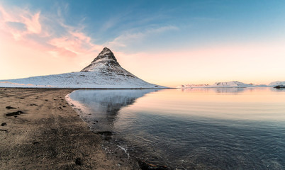 Kirkjufell view during winter snow which is a high mountain on the north coast of Iceland's Snaefellsnes peninsula, near the town of Grundarfjordur 