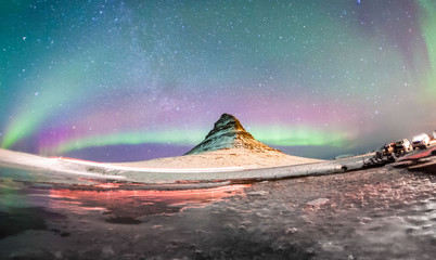 Colorful Aurora Borealis or better known as The Northern Lights and winter milky way over Kirkjufell, Iceland © keongdagreat