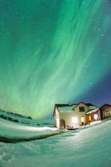 Colorful Aurora Borealis or better known as The Northern Lights and winter milky way over Kirkjufell, Iceland