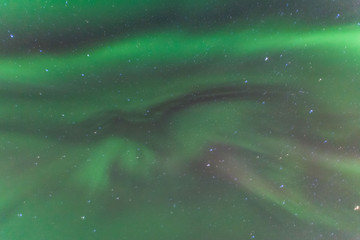 Colorful Aurora Borealis or better known as The Northern Lights and winter milky way over Kirkjufell, Iceland