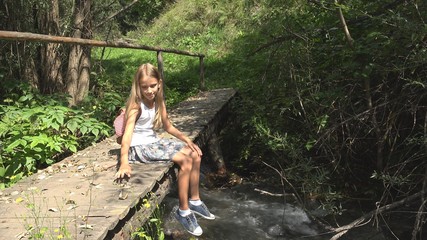 Naklejka na ściany i meble Child on Bridge in Mountains, Kid Hiking in Nature, Girl Looking a River, Stream