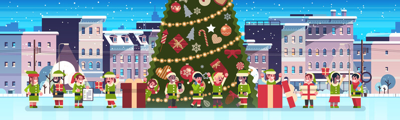 mix race elves group near decorated fir tree city building houses night winter street cityscape merry christmas happy new year concept flat horizontal banner vector illustration