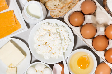 assortment of fresh dairy products on white background, top view