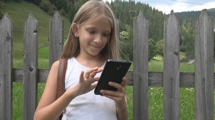 Child Playing Smartphone Outdoor, Kid on Tablet, Girl Relaxing in Nature