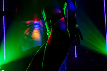 ass young guy gay in sexy underwear on colored lights clubs background