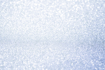 Abstract silver glitter bokeh lights with soft light background.
