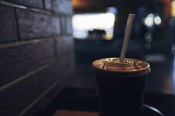 delicious drink with a straw stands on a shelf