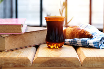reading books and eating homemade croissant, drinking hot turkish tea on a sunny terrace