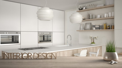 Wooden table, desk or shelf with potted grass plant, house keys and 3D letters making the words interior design, over blurred modern kitchen, project concept copy space background