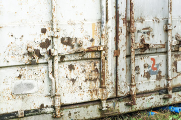 Old damaged rusty shipping container locking system,