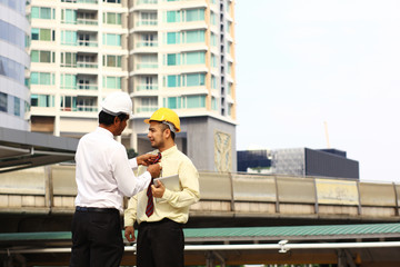 Senior Engineer or manager arrange necktie his worker on site line