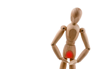 Wooden dummy has pain in genitals on white background. Concept of health issues.