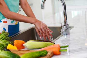 young cook or maid wash and clean her hand before and after make food in kitchen