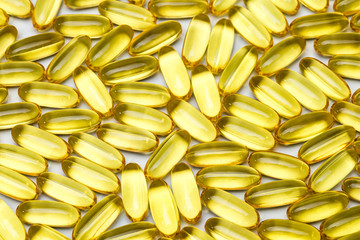 Photo background of yellow healthy vitamin d in capsules